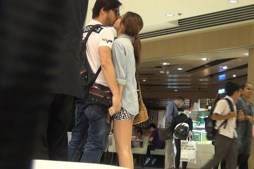 Director Oxide Pang was caught kissing model Liddy Li in a queue for movie tickets in Hong Kong on May 23, 2014. -- PHOTO: APPLE DAILY &nbsp;