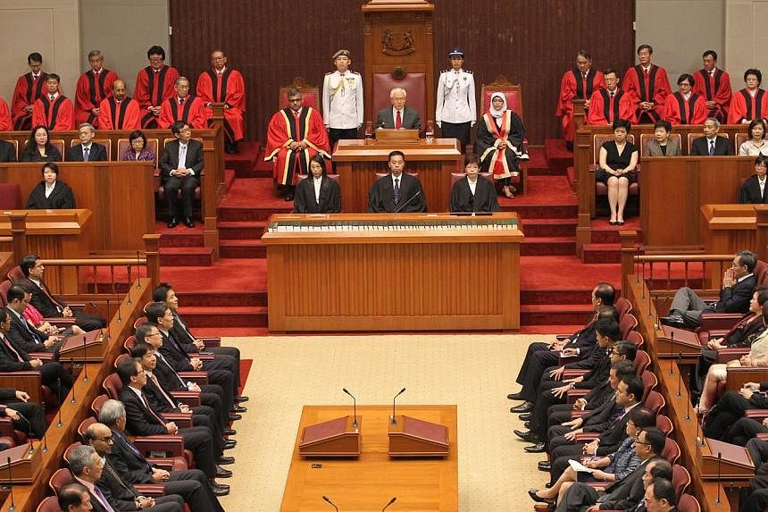 President Tony Tan Keng Yam (centre), flanked by Speaker of Parliament Halimah Yacob (right) and Chief Justice Sundaresh Menon (left), delivering his address at the opening of the second session of the 12th Parliament on 16 May 2014. -- PHOTO: ST FIL