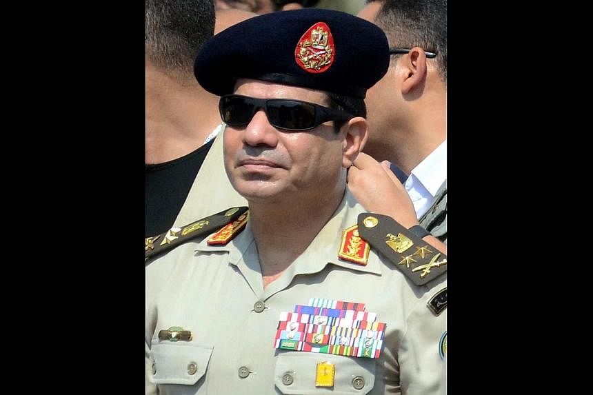 A Sept 20, 2013, file picture shows Egypt's then Defence Minister and military chief Abdel Fattah al-Sisi attending the funeral of Giza security chief Nabil Farrag in the district of Giza.&nbsp;The former general has scored a crushing presidential el