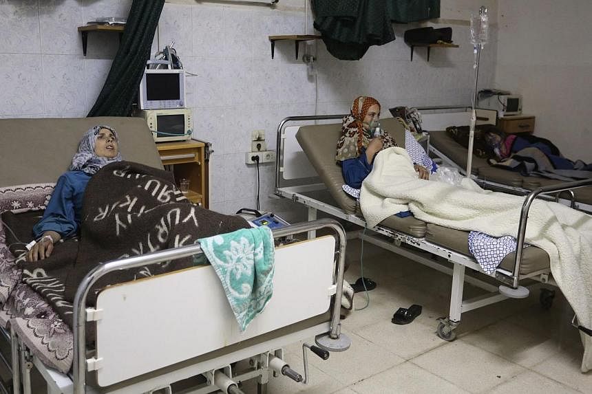 People, affected by what activists say was a gas attack, receive treatment inside a makeshift hospital in Kfar Zeita village in Hama. The destruction of Syria's chemical weapons arsenal will not be completed before a June 30 deadline agreed after Was