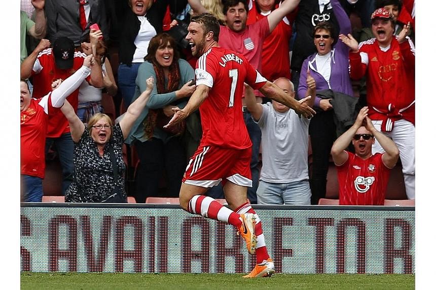 Southampton's Rickie Lambert celebrates after scoring against Manchester United during their English Premier League match at St Mary's Stadium on May 11, 2014.&nbsp;Lambert is set for a medical at Liverpool on Saturday after a fee of £4 million (S$8