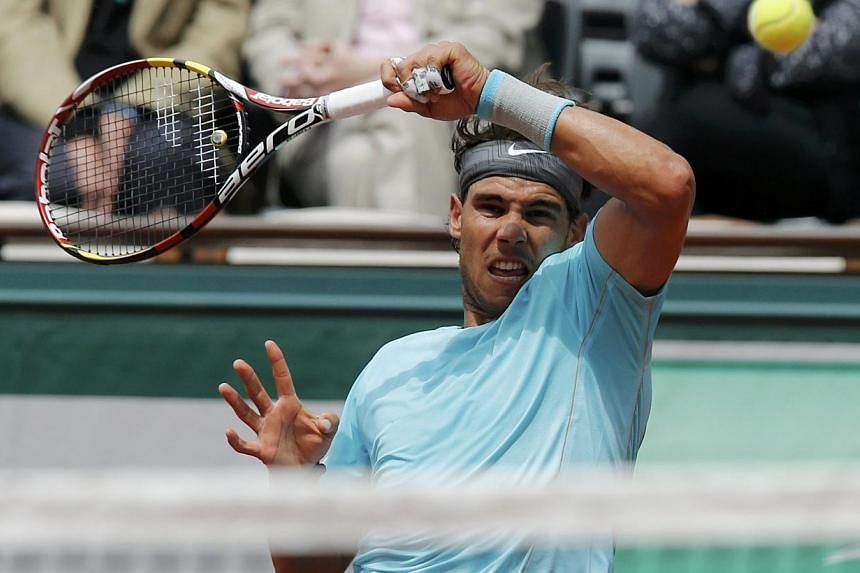 Rafael Nadal of Spain returns a forehand to Dominic Thiem of Austria during their men's singles match at the French Open tennis tournament at the Roland Garros stadium in Paris on May 29, 2014. -- PHOTO: REUTERS
