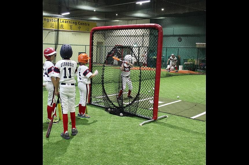 Children practising in a baseball batting cage at The Hit Factory. -- PHOTO: THE HIT FACTORY