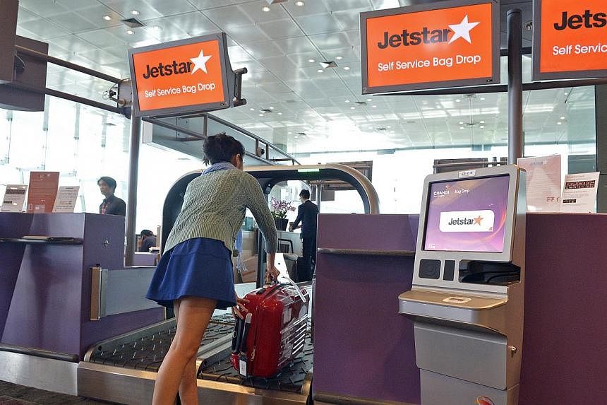 (Clockwise from top left) The Jetstar passenger just has to print out the luggage tag at the kiosk, attach the tag to the bag and drop it off at the designated area.