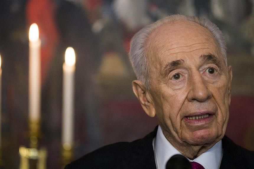 Israel's President Shimon Peres answers questions at a press meeting on the first day of his official visit in Oslo on May 12, 2014. -- PHOTO: AFP