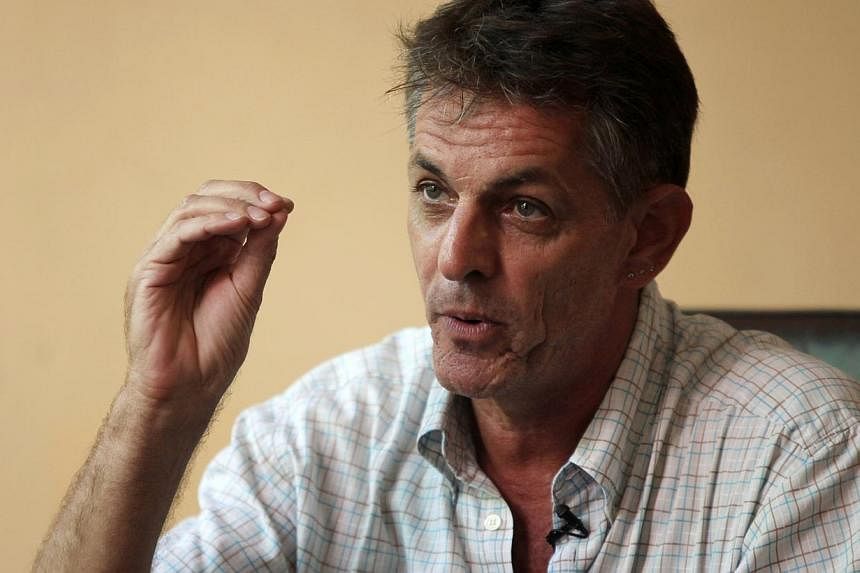 Pierre Legros, former husband of Cambodian activist Somaly Mam who is known globally for her fight against sex trafficking, gestures during an interview with Reuters in Phnom Penh on May 29, 2014. -- PHOTO: REUTERS