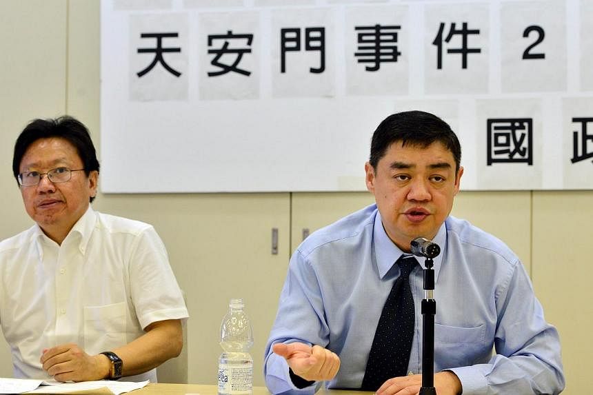 Former Chinese dissident leader Wu'er Kaixi (R) speaks at a seminar for the 25th anniversary of the 1989 crackdown at Tiananmen square in Tokyo on May 30, 2014, while Chinese author Chen Pokong (L) looks on. China's pro-Democracy activists, including