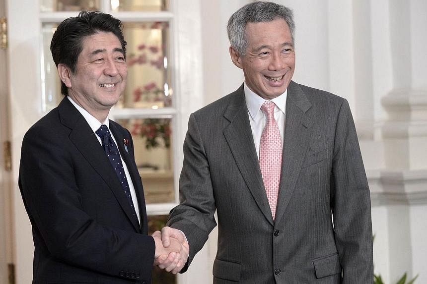 Japanese Prime Minister Shinzo Abe (left) shakes hands with Singapore Prime Minister Lee Hsien Loong (right) during a meeting at Istana Presidential Palace in Singapore, on May 31, 2014. Singapore welcomes Japan's desire to contribute to peace and se