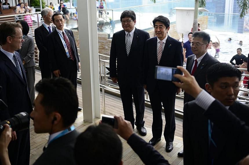 Japanese Prime Minister Shinzo Abe (third from right) touring the Marina Bay Sands integrated resort yesterday, accompanied by chief executive officer George Tanasijevich (far left). Japan is said to be mulling plans to liberalise its casino industry