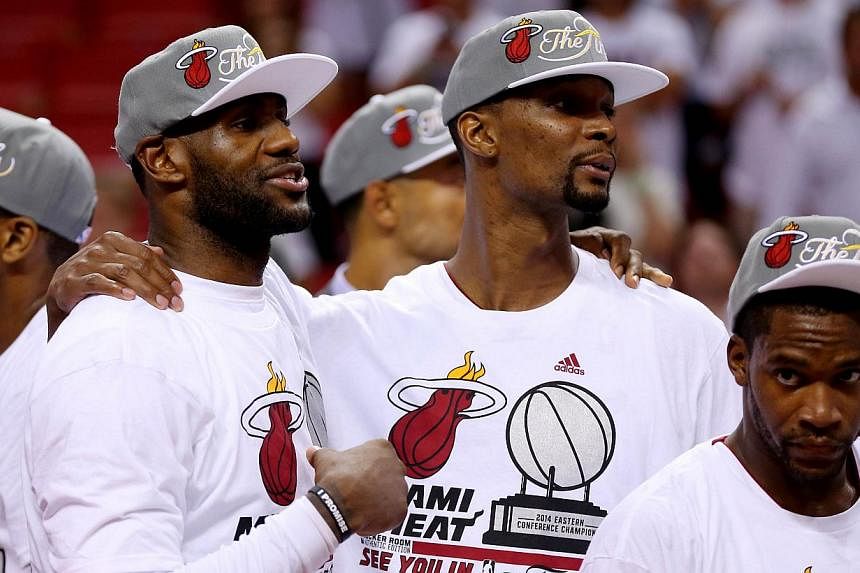 LeBron James, Chris Bosh and Toney Douglas of the Miami Heat celebrate after defeating the Indiana Pacers in Game Six of the Eastern Conference Finals of the 2014 NBA Playoffs at American Airlines Arena on May 30, 2014 in Miami, Florida.&nbsp;James a