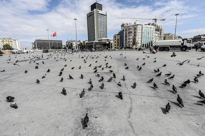 Pigeons roam around an empty Taksim Square on May 31, 2014, after police closed off access to the square during the one year anniversary of the Gezi Park and Taksim Square demonstrations.&nbsp;Turkey's combative prime&nbsp;minister warned protesters 