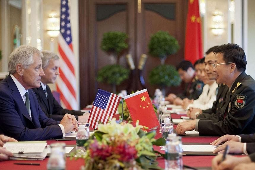 US Defense Secretary Chuck Hagel (left) listens to Lieutenant-General Wang Guanzhong, deputy chief of the general staff of the People's Liberation Army, during the start of their meeting in Singapore on Saturday, May 31, 2014. -- PHOTO: REUTERS