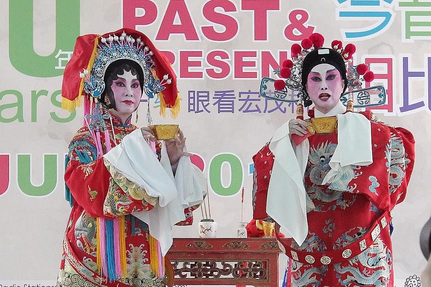 Cantonese opera singers performing on stage on June 1, 2014, at the opening of the 30 Years - Ang Mo Kio Past To Present festival village, as part of the PAssionArts Festival 2014 by the People's Association. -- ST PHOTO: NEO XIAOBIN