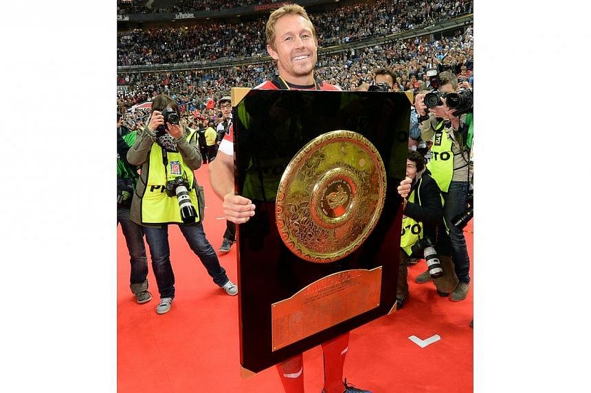 RC Toulon's British fly-half Jonny Wilkinson carries the Top 14 championship "Bouclier de Brennus" (Brennus shield) trophy after winning the French Top 14 rugby union final between Castres Olympique and RC Toulon, at the Stade de France stadium in Sa