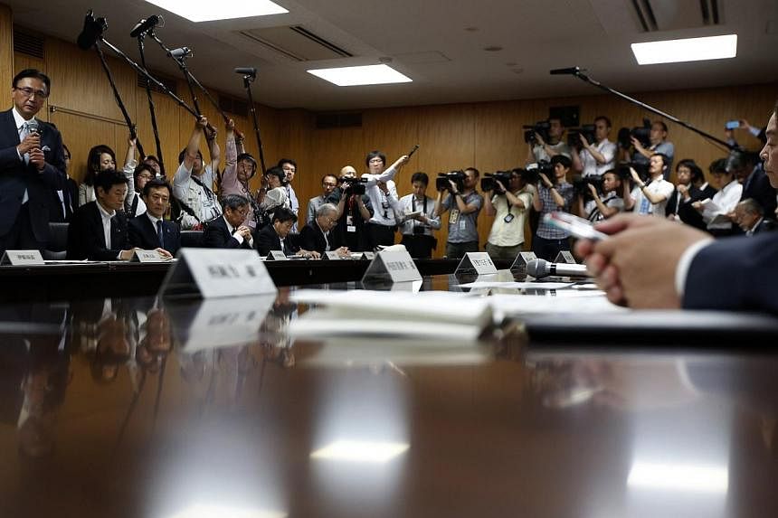 Japan's Minister-in-Charge of the Abduction Issue and head of the national public safety commission Keiji Furuya (left) speaks to the family members of victims kidnapped by North Korea, in Tokyo on May 30, 2014. -- PHOTO: REUTERS