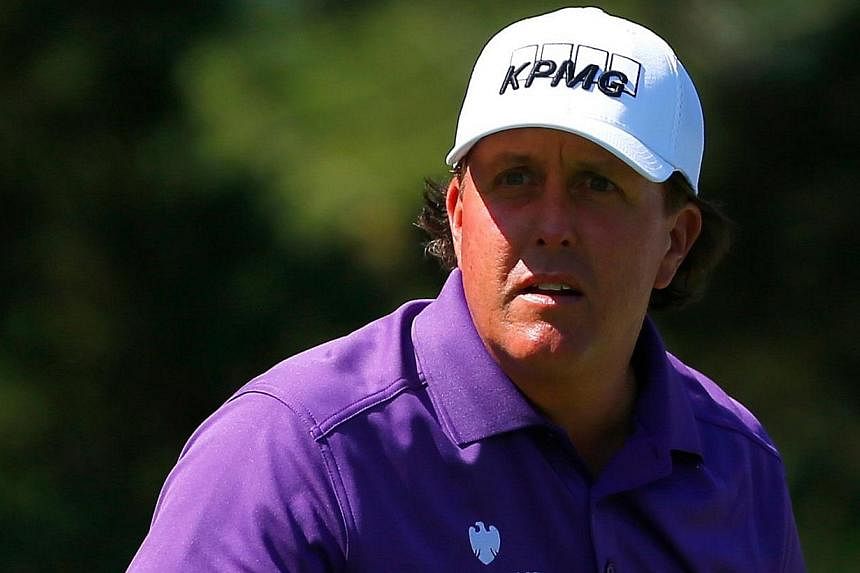 Five-time major golf champion Phil Mickelson denied any wrongdoing on Saturday after being named among the subjects of an insider stock trading probe, saying he is fully cooperating with FBI agents. -- PHOTO: AFP