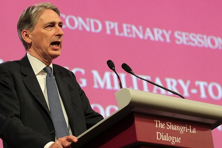 UK's Secretary of State for Defence Philip Hammond speaks at the 2nd plenary session of the 13th International Institute for Strategic Studies (IISS) Shangri-La Dialogue (SLD) on May 31, 2014, in Singapore.&nbsp;British Defence Minister Philip Hammon