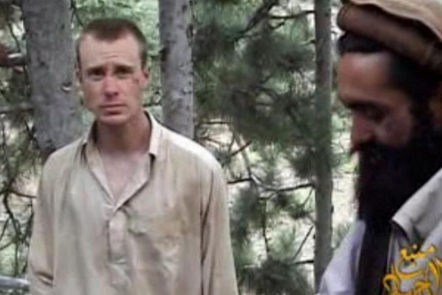 This still image provided on Dec 7, 2010, by IntelCenter shows the Taliban associated video production group Manba al-Jihad Dec 7, 2010, release of US Sergeant Bowe Bergdahl (left), who has been held hostage by the Taliban since his disappearance fro