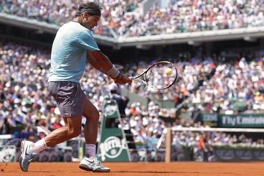 Spain's Rafael Nadal hits a return to Argentina's Leonardo Mayer during their French tennis Open third round match at the Roland Garros stadium in Paris on May 31, 2014. -- PHOTO: AFP