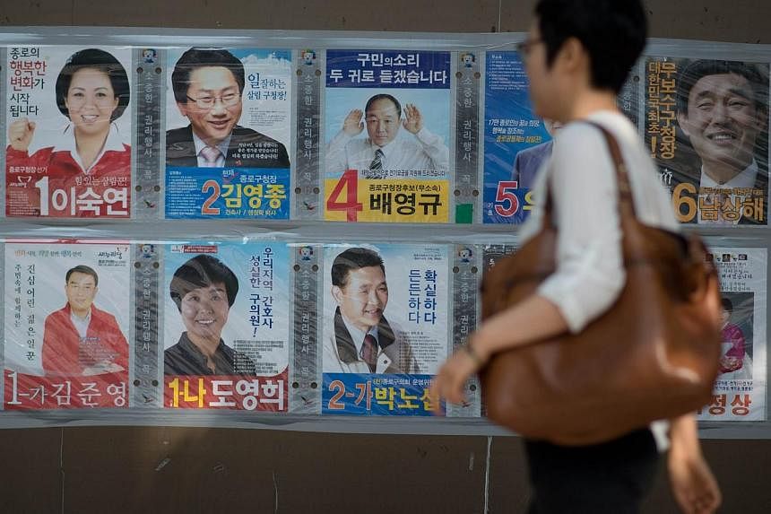The posters of local election candidates are dispolayed on a wall in Seoul on May 29, 2014.&nbsp;South Koreans elect new local representatives on Wednesday in elections widely seen as a barometer of President Park Geun Hye's response to a ferry disas