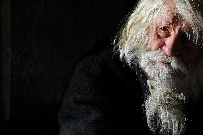 The 100-year-old Dobri Dobrev, known as "Grandpa" Dobri, begs for alms in the porch of the golden-doomed Alexander Nevski cathedral, in the center of Sofia, on April 20, 2014. -- PHOTO: AFP