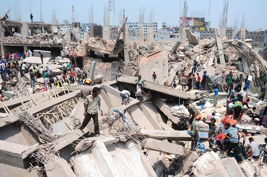Bangladeshi civilian volunteers assist in rescue operations after an eight-storey building collapsed in Savar, on the outskirts of Dhaka on April 24, 2013.&nbsp;The Bangladesh government is refusing to shut down garment factories declared unsafe, fol