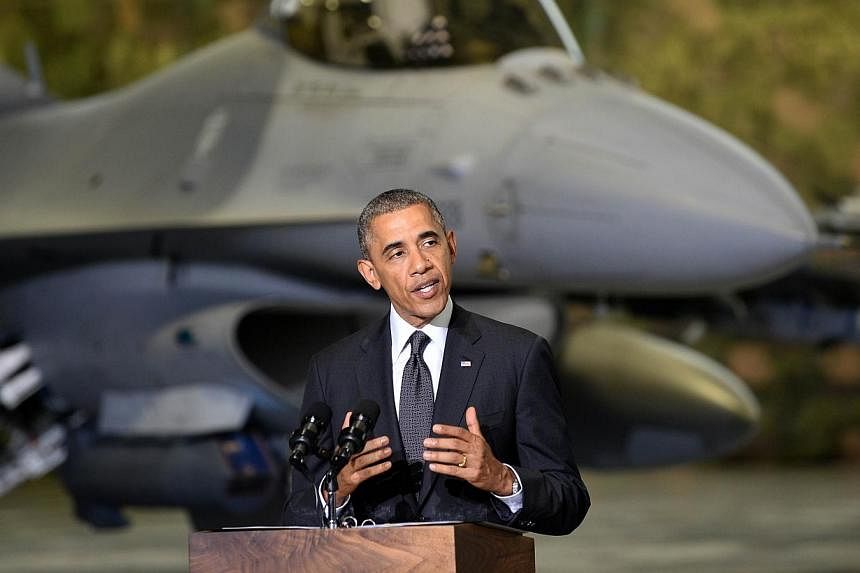 US President Barack Obama addresses US and Polish airmen in front of a F-16 fighter jet in a hangar at Warsaw Chopin Airport, Poland, on June 3, 2014.&nbsp;Mr Obama proposed an initiative of up to US$1 billion (S$1.26 billion) to finance extra US tro