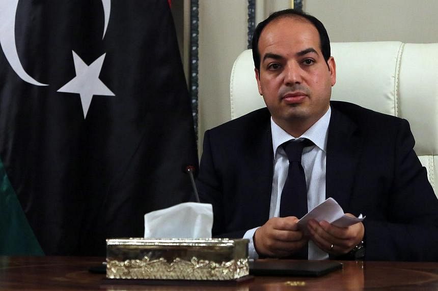New Libyan Prime Minister Ahmed Miitig meets with his ministers for the first time on June 2, 2014 in Tripoli. -- PHOTO: AFP