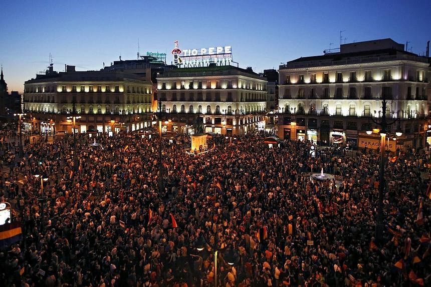 People take part in an anti-monarchist demonstration at Madrid's landmark Puerta del Sol Square, following the announcement of the abdication of Spain's King Juan Carlos, on June 2, 2014.&nbsp;Thousands of anti-royalists took to the streets across Sp