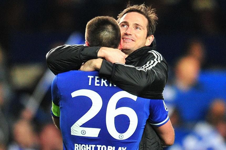 Chelsea's English defender John Terry (left) celebrates their victory with Chelsea's English midfielder Frank Lampard (right) after the final whistle during the Uefta Champions League quarter final second leg football match between Chelsea and Paris 