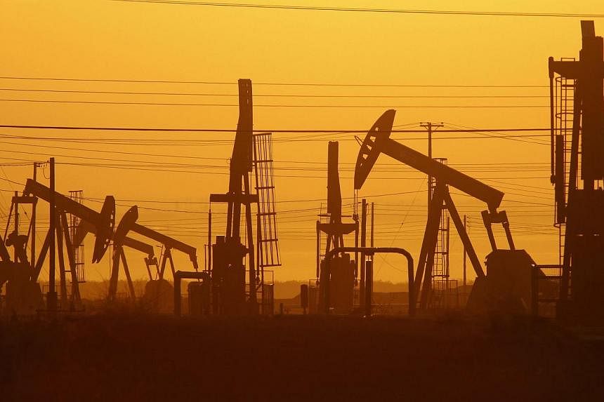 Pump jacks are seen at dawn in an oil field over the Monterey Shale formation on March 24, 2014 near Lost Hills, California. More than US$48 trillion (S$60.3 trillion) must be invested by 2035 to meet global energy needs as current technologies go of