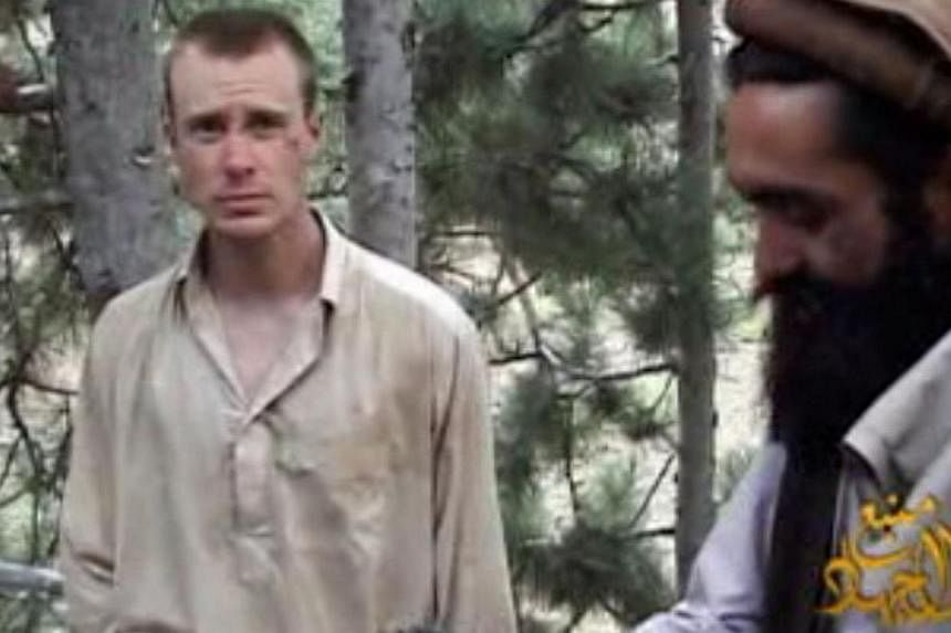 This still image provided on Dec 7, 2010 by IntelCenter shows the Taliban associated video production group Manba al-Jihad on Dec 7, 2010 release of US Sergeant Bowe Bergdahl (left), who has been held hostage by the Taliban since his disappearance fr