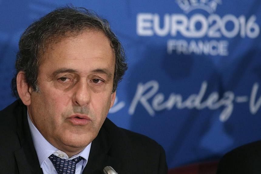 Uefa president Michel Platini attends a news conference after a meeting held in preparation of the EURO 2016 soccer tournament in Paris on April 25, 2014. Platini on Tuesday attacked a British newspaper for seeking to "tarnish" his reputation by draw