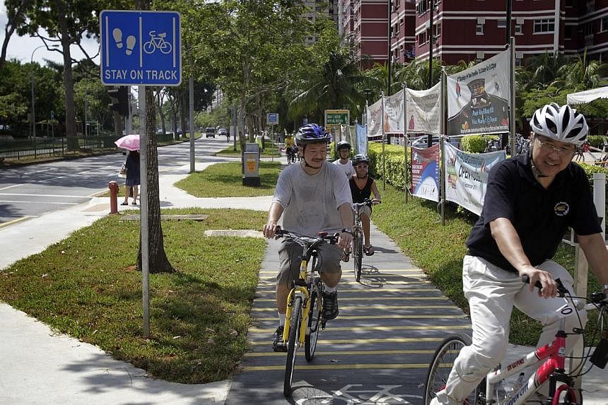 Cyclists trying out the new dedicated cycling path along Pasir Ris Drive 3. Giving priority to street-level crossings, providing protected bike lanes and setting lower speed limits for motorists are ways to promote walking and cycling in Singapore, s