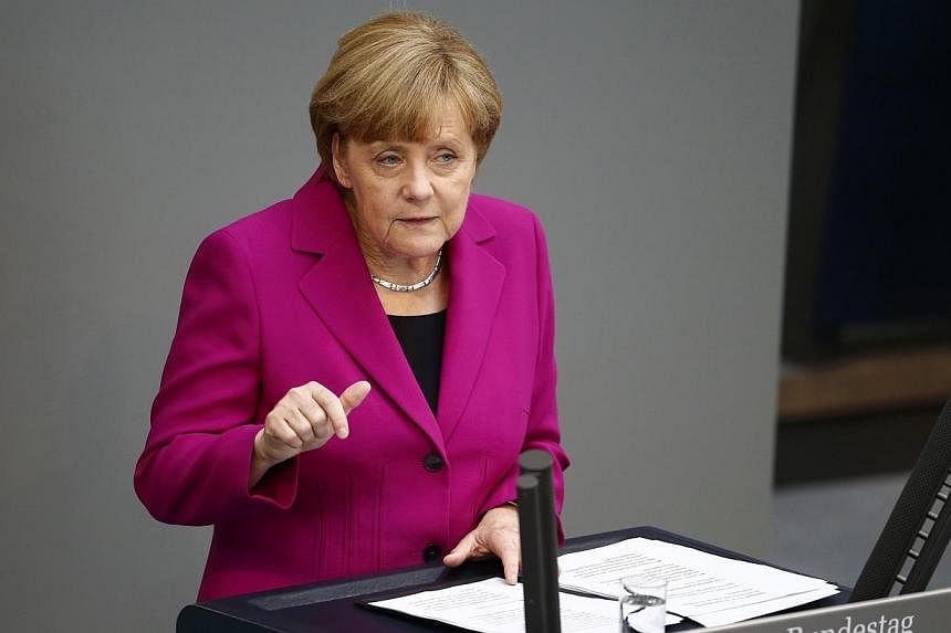 German Chancellor Angela Merkel addresses a session of the Bundestag, the lower house of Parliament, at the Reichstag in Berlin on June 4, 2014.&nbsp;German Chancellor Angela Merkel said on Wednesday, June 4, 2014, she would not hesitate to impose ec