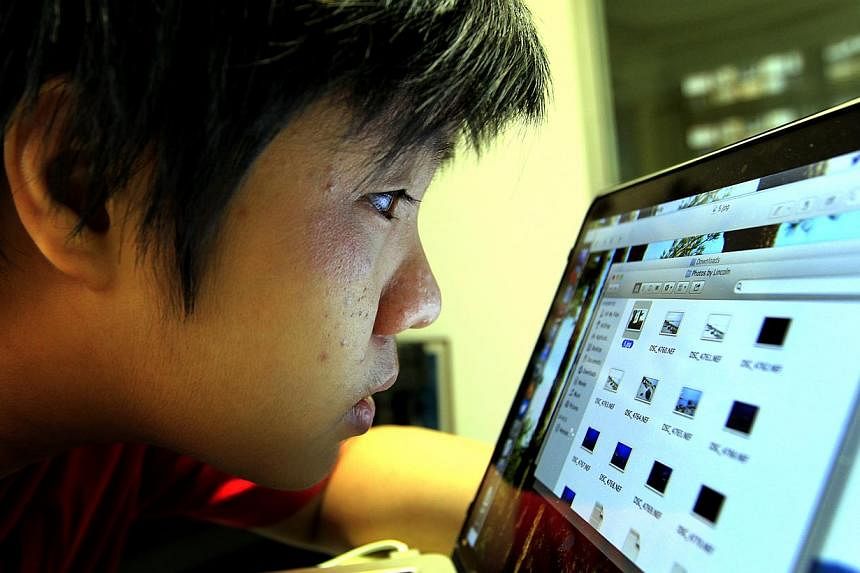 St Hilda’s Secondary School student Joshua Tseng has to peer closely at a computer screen to make out what is on it. Looking through his right eye is like looking through a frosted pane, and his left eye can only make out shapes, colours and light.