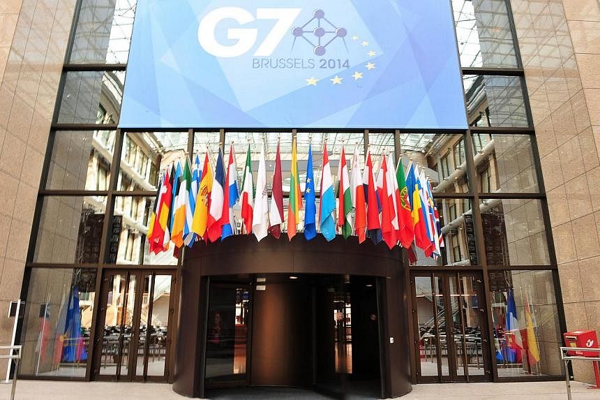 A view of a sign announcing the upcoming G7 summit, in front of the atrium of the European Union Council Building, which was transformed into a press center for the occasion, at the EU Headquarters in Brussels, on June 2, 2014. -- PHOTO: AFP