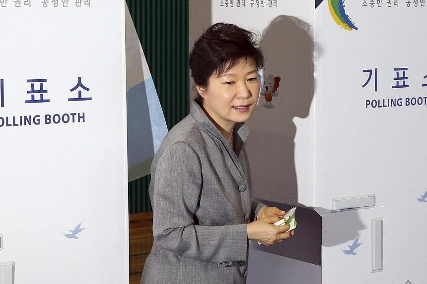 South Korean President Park Geun-hye walks out a voting booth after marking her ballots for the local elections at a polling station in Seoul on June 4, 2014.&nbsp;Exit polls in South Korean local elections on Wednesday, June 4, 2014, signalled the t