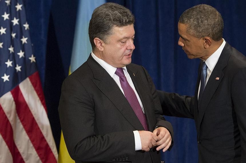US President Barack Obama and President-elect Petro Poroshenko of Ukraine talk during a meeting in Warsaw, Poland, on June 4, 2014.&nbsp;Mr Obama met Mr Poroshenko on Wednesday, in a show of US support for Ukraine's right to chart its own future, bef