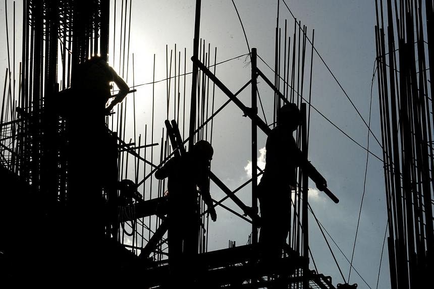 Labourers are silhouetted as they work on a building construction site in suburban Manila on April 1, 2014. Construction can be all around the metropolis: condominiums, office buildings, highways, airports, interchanges. But&nbsp;who's getting the li