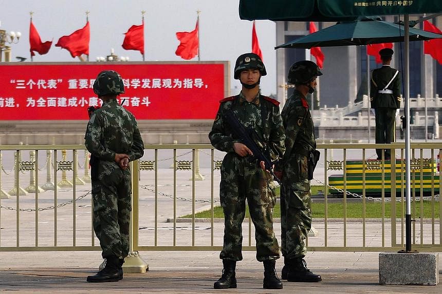 Paramilitary policemen stand guard at the Monument to the People's Heroes at Tiananmen Square near the Great Hall of the People, ahead of the 25th anniversary of the crackdown on pro-democracy protests, in Beijing on June 3, 2014. -- PHOTO: REUTERS