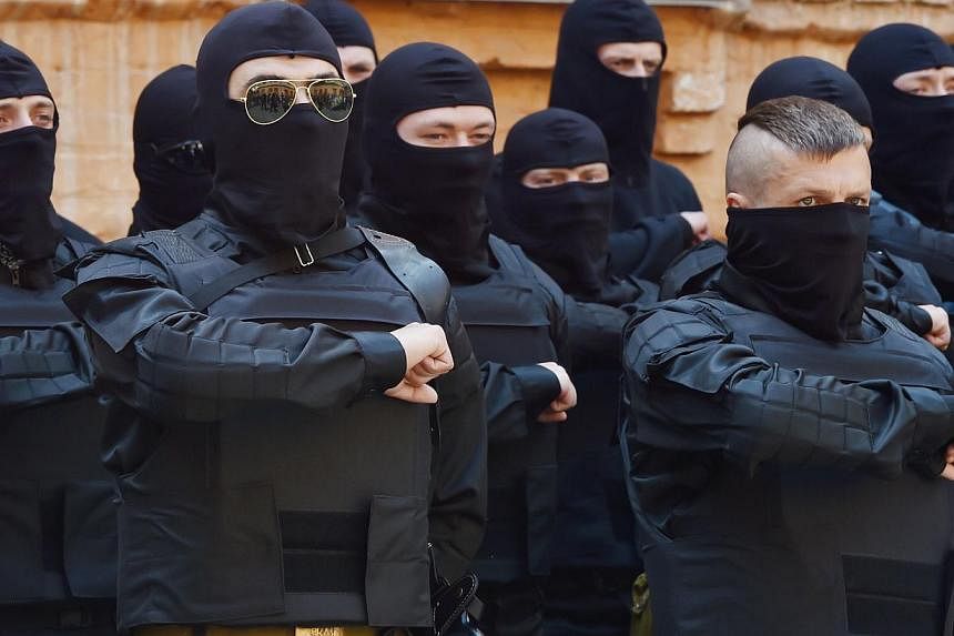 Fighters of Social Nationalist Assembly (SNA), part of ultra-nationalist Right Sector party, swear in Kiev prior their leaving on June 3, 2014.&nbsp;Government forces pressed on with an offensive against pro-Russia separatists in eastern Ukraine on W
