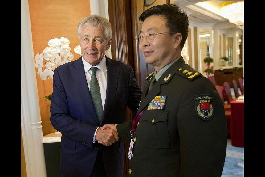 US Defence Secretary Chuck Hagel (left) meeting China's Lt-Gen Wang Guanzhong, the deputy chief of general staff of the People's Liberation Army, in Singapore last Saturday.