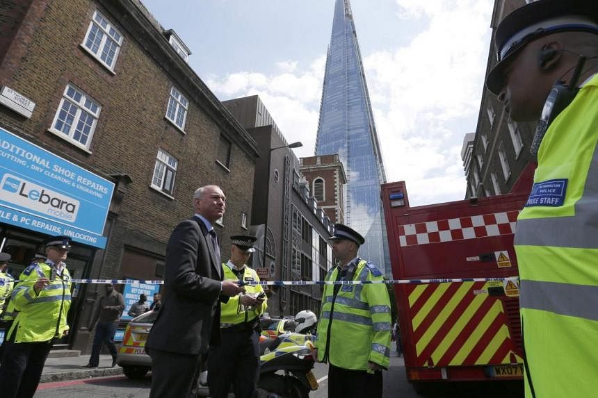 Police officers block streets near The Shard skyscaper in central London on June 5, 2014.&nbsp;London's tallest building, The Shard, was evacuated for several hours on Thursday, June 5, 2014 after smoke started billowing from the basement of the 87-s