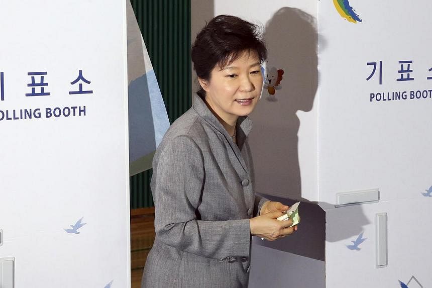 South Korean President Park Geun Hye walks out a voting booth after marking her ballots for the local elections at a polling station in Seoul on June 4, 2014. -- PHOTO: REUTERS