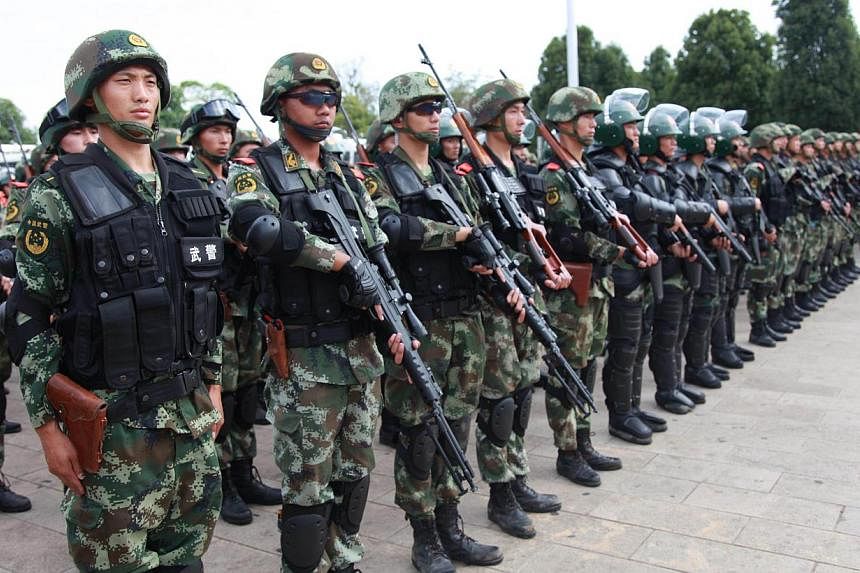 Paramilitary police attending a ceremony of an anti-terrorism campaign in Honghe, southwest China's Yunnan province on June 3, 2014. -- PHOTO: AFP