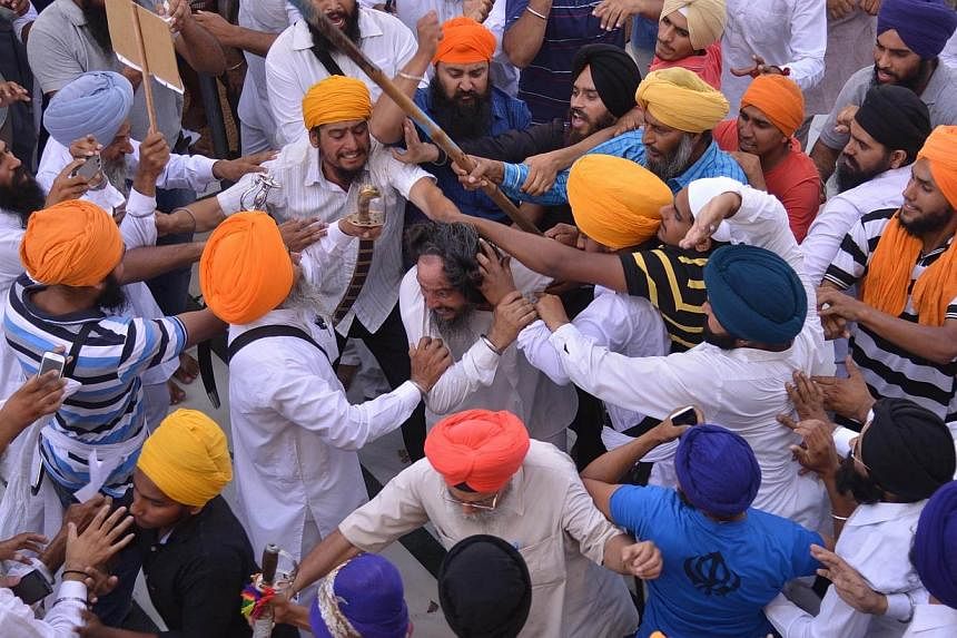 Sikh activists clash with members of the Shiromani Gurudwara Prabhandak Committee (SGPC) during commemorations for the 30th Anniversary of Operation Blue Star at the Golden Temple in Amritsar on June 6, 2014. -- PHOTO: AFP