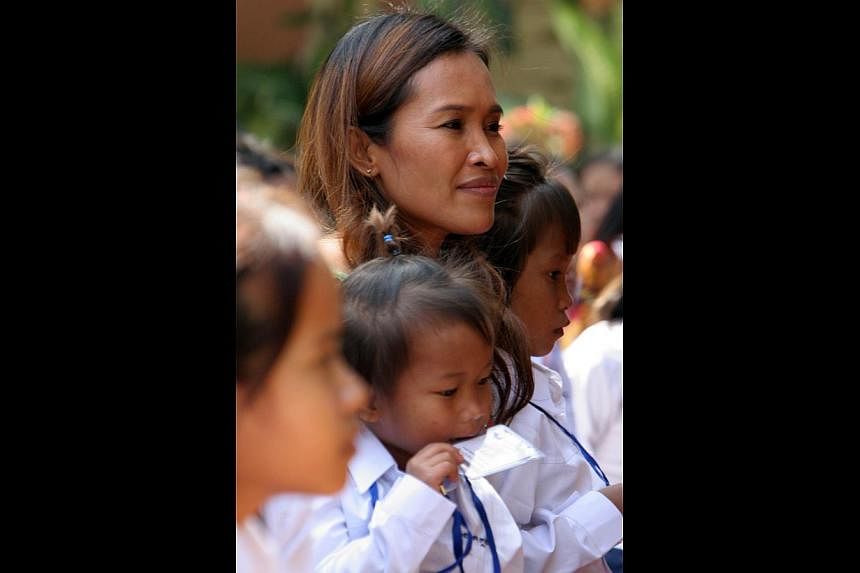 Ms Mam with Cambodian children at a vocational training centre in Phnom Penh in 2008. Her fans have now learnt she had fabricated much of the story used to raise millions of dollars over a decade or so.