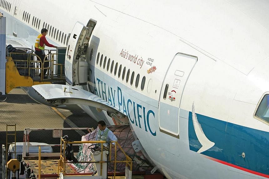 Air staff prepare a Cathay Pacific Airways Ltd. jet at Hong Kong International Airport in Hong Kong, China. The Hong Kong Airport Authority and two airlines said on Friday they had received a warning from Taiwan authorities regarding a possible bomb 