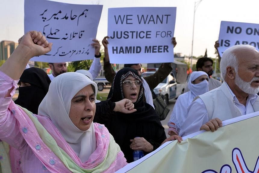 Pakistani activists from the Defence of Human Rights Pakistan organisation shout slogans during a protest against the attack on television journalist Hamid Mir by gunmen in Islamabad on April 22, 2014. A leading Pakistani journalist and TV anchor who